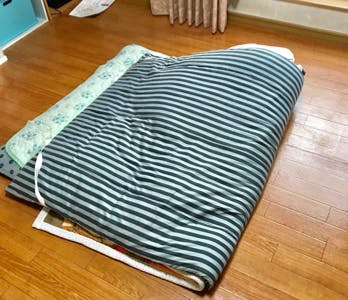 木製床の上に置かれている机 低い精度で自動的に生成された説明